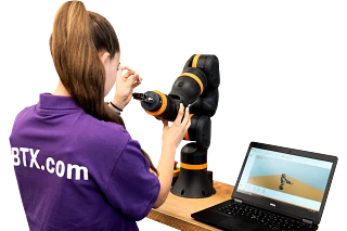 Woman from behind, working on a robot