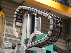 Suction hose within a bracket chain 