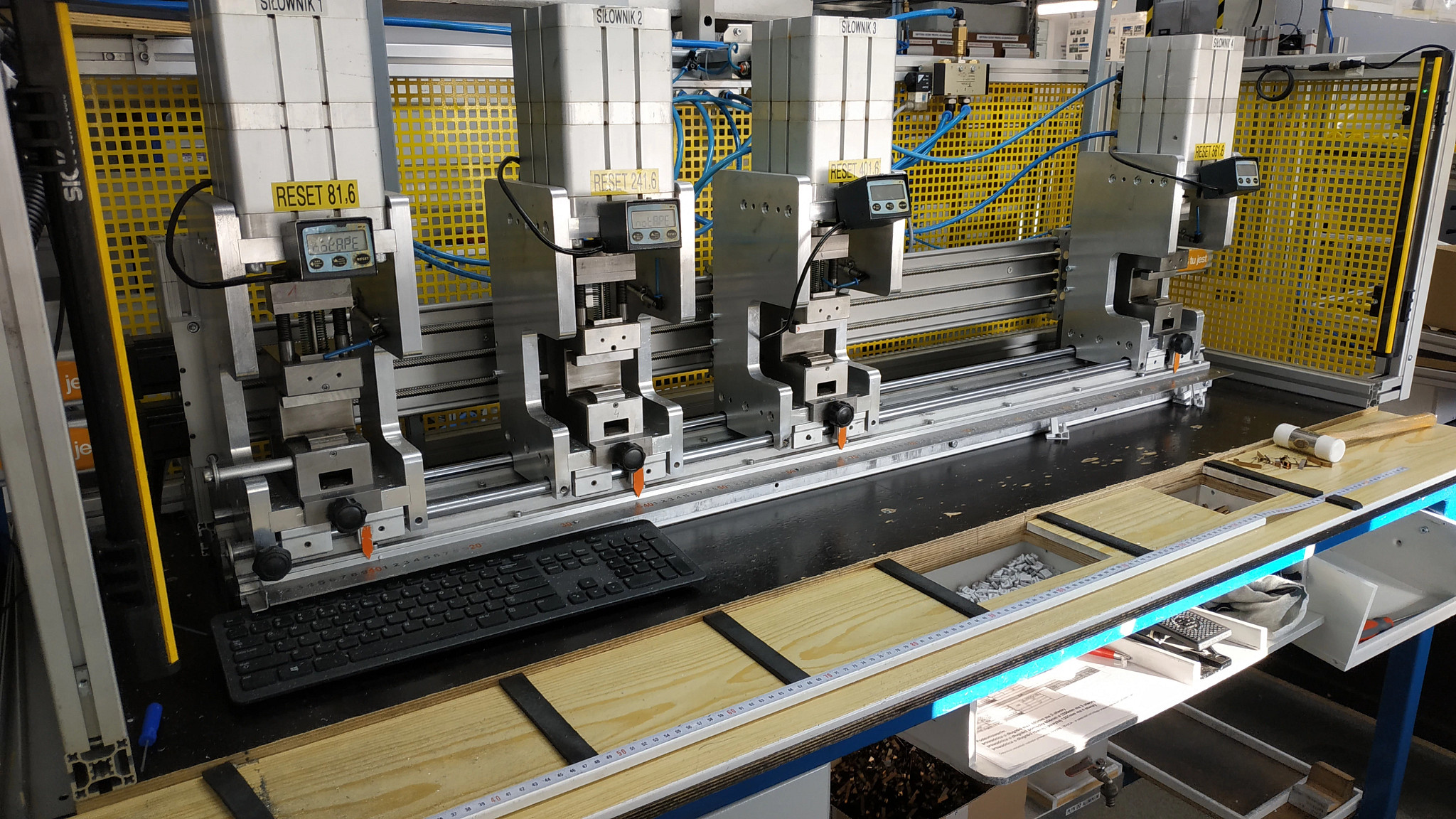 A machine that punches holes in rolling shutter sidebars.