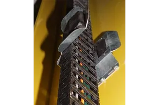 Two automatically actuated compensators hold the chain in the trough segments.