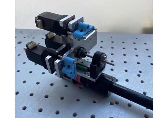 The blue 3D-printed clamps fasten the linear actuators.