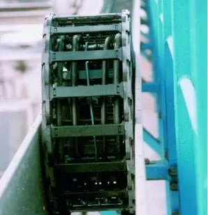 Series 5050 cable carrier, center mounted in stainless steel guide trough