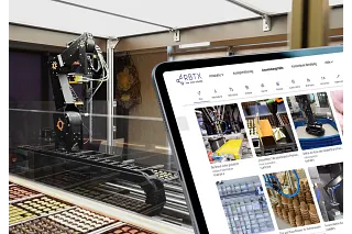 Laptop with robot in background