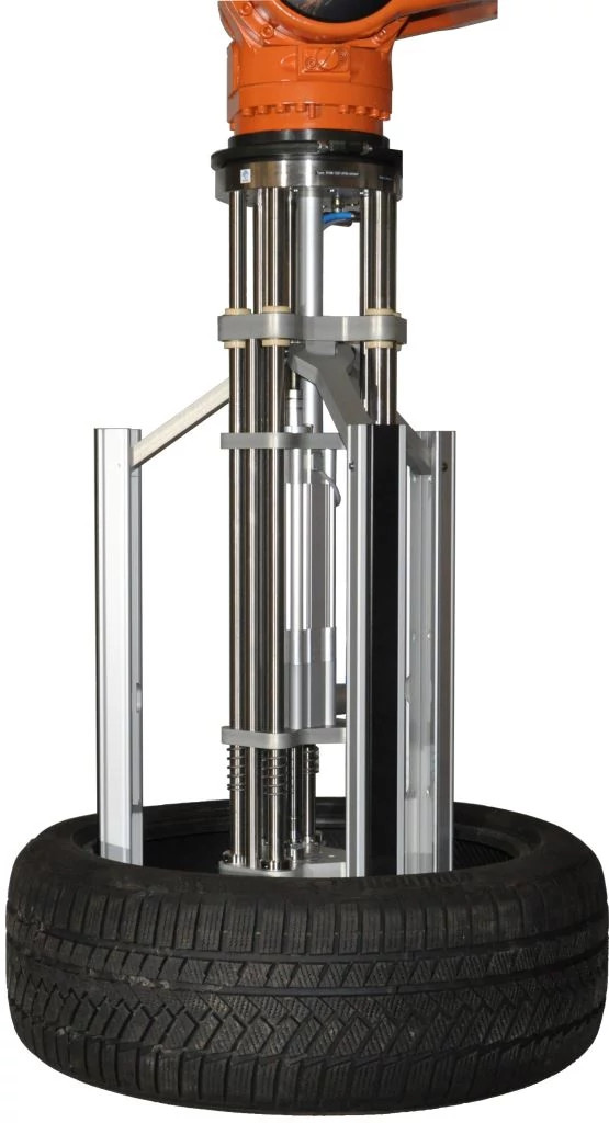 Long arm gripper lifts tyres