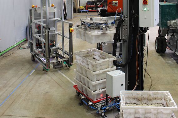 An automated guided vehicle system drives to the worm container removal station