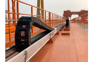 Compact Energy Chain Energy chains supply 16 trolleys on 15,000t shipyard crane | igus Canada