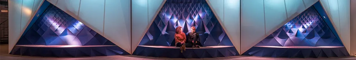 Two women sit in front of the "Europe Building in Amsterdam