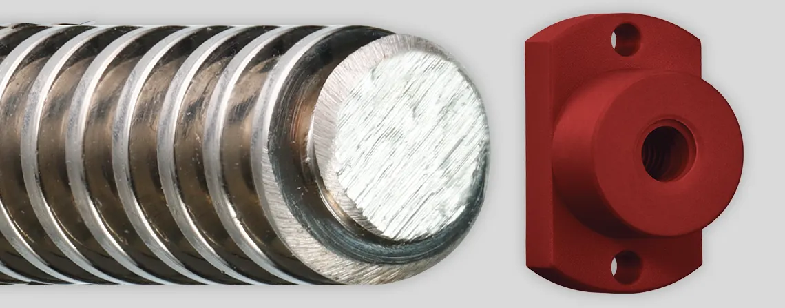 Three trapezoidal lead screw nuts lined up from left to right: the first is a white cylindrical nut with counterclockwise grooves spiraling inward. The second is a dark maroon nut with a tall rectangular backing featuring three holes: a small hole at the top and bottom, and a larger hole with counterclockwise grooves. The third is a light tan nut with a thin cylindrical backing, featuring six evenly spaced small holes around its face, and a large hole with counterclockwise grooves spiraling to the back.