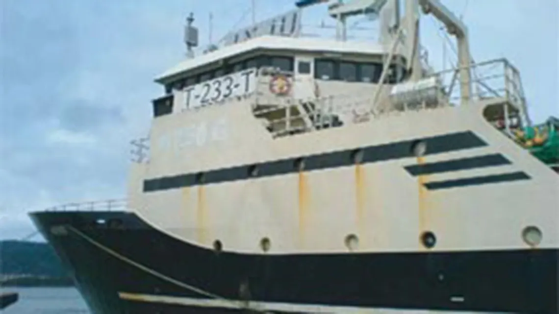 Fishing trawler with de-heading and gutting machines below deck.