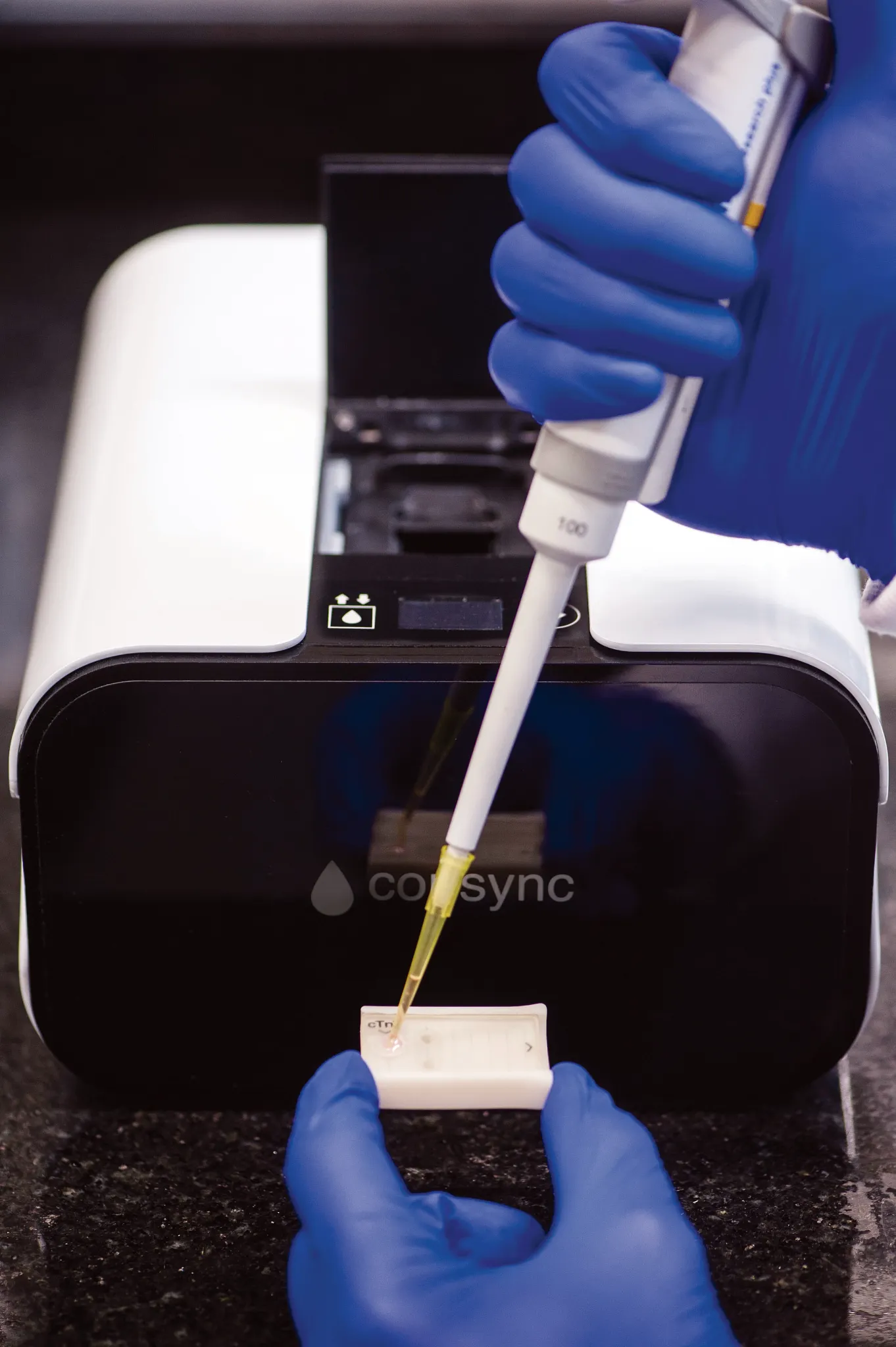 The blood sample is taken from the patient and placed in the device.