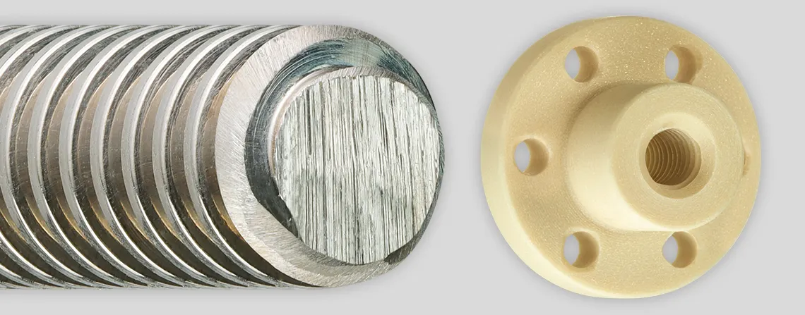 Three metric lead screw nuts lined up from left to right: the first is a white cylindrical nut with counterclockwise grooves spiraling inward. The second is a dark maroon cylindrical nut with a tall rectangular backing, featuring three holes—small holes at the top and bottom, and a larger hole with spiraling counterclockwise grooves. The third is a light tan cylindrical nut with a thinner backing, featuring six evenly spaced small holes and a large hole with counterclockwise grooves spiraling to the back.